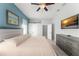 This serene main bedroom is adorned with cool colors and features a ceiling fan at 10064 River Glen Ct, Orlando, FL 32825
