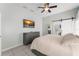 This serene main bedroom has a ceiling fan and en suite bath with barn door at 10064 River Glen Ct, Orlando, FL 32825