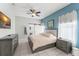 This serene main bedroom is adorned with cool colors and features a ceiling fan at 10064 River Glen Ct, Orlando, FL 32825