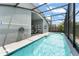 Sparkling pool with tiled edge and a screened enclosure with view of the backyard at 10064 River Glen Ct, Orlando, FL 32825