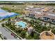 Aerial view of the community pool with a large pool deck, lush landscaping, playground and ample parking at 10630 Mobberley Cir, Orlando, FL 32832