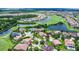 Aerial view of neighborhood with a home outlined in red, near lake, pond, and golf course at 10630 Mobberley Cir, Orlando, FL 32832