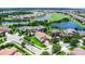 Aerial view of a residential neighborhood with homes, ponds, and a golf course at 10630 Mobberley Cir, Orlando, FL 32832