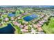 An aerial view of a community surrounded by a golf course, ponds, lakes, and lush landscaping at 10630 Mobberley Cir, Orlando, FL 32832