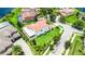 Aerial view of a home with a red tile roof, solar panels, and lush landscaping at 10630 Mobberley Cir, Orlando, FL 32832