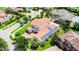 Aerial view of a residence featuring a red tile roof, solar panels, and mature landscaping at 10630 Mobberley Cir, Orlando, FL 32832