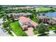 Stunning aerial view of the home with a red tile roof and lush landscaping, near a pond and golf course at 10630 Mobberley Cir, Orlando, FL 32832