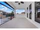Covered balcony with tile flooring, black metal railing, and a view of the surrounding neighborhood at 10630 Mobberley Cir, Orlando, FL 32832