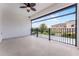 Open-air balcony with tile flooring, black metal railing, and neighborhood views at 10630 Mobberley Cir, Orlando, FL 32832