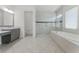Bathroom features a glass shower, soaking tub, tiled floor and dual vanity at 10630 Mobberley Cir, Orlando, FL 32832