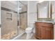 Modern bathroom featuring a glass enclosed shower with mosaic tile accents and granite countertop vanity at 10630 Mobberley Cir, Orlando, FL 32832