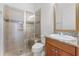 Well-lit bathroom featuring a glass shower, toilet, and granite vanity with modern fixtures at 10630 Mobberley Cir, Orlando, FL 32832