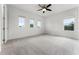 Bright and spacious bedroom with plush carpeting, a ceiling fan, and three windows offering natural light at 10630 Mobberley Cir, Orlando, FL 32832