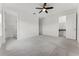 Large bedroom with plush carpet and a ceiling fan featuring an ensuite bath and walk-in closet at 10630 Mobberley Cir, Orlando, FL 32832