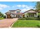 Elegant two-story home with a beautiful brick driveway and well-maintained landscaping at 10630 Mobberley Cir, Orlando, FL 32832