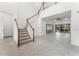 Bright foyer with a staircase, tiled floors, and an open view of the living area at 10630 Mobberley Cir, Orlando, FL 32832