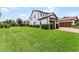 Beautiful two-story home with attached three-car garage, complemented by a green lawn and manicured landscaping at 10630 Mobberley Cir, Orlando, FL 32832