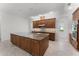 A spacious kitchen boasts an island with granite countertops and modern, stainless steel appliances at 10630 Mobberley Cir, Orlando, FL 32832