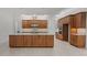 A kitchen features stainless steel appliances, granite countertops, wood cabinets, and a center island at 10630 Mobberley Cir, Orlando, FL 32832