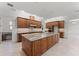 Gourmet kitchen featuring a large granite island, custom cabinetry, and modern appliances at 10630 Mobberley Cir, Orlando, FL 32832