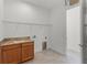 A laundry room features a sink, countertop, and connections for a washer and dryer at 10630 Mobberley Cir, Orlando, FL 32832