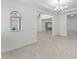 An open floorplan shows the flow from the living area to the entryway, staircase, and other rooms at 10630 Mobberley Cir, Orlando, FL 32832