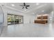 A bright living room features tile flooring, a ceiling fan, sliding glass doors, and an open concept layout at 10630 Mobberley Cir, Orlando, FL 32832