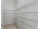 A walk-in pantry provides ample storage with metal shelving from floor to ceiling at 10630 Mobberley Cir, Orlando, FL 32832