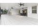 Large, tiled sunroom featuring an outdoor kitchen and a dining area, perfect for entertaining at 10630 Mobberley Cir, Orlando, FL 32832