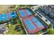 Aerial view of community tennis and basketball courts showcasing their layout and condition at 10630 Mobberley Cir, Orlando, FL 32832
