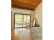 Bedroom with wooden floors and sliding glass doors accessing a private balcony at 116 Palm View Ct # 3535/6, Haines City, FL 33844