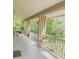Inviting, covered porch with white railings and views of lush greenery at 116 Palm View Ct # 3535/6, Haines City, FL 33844