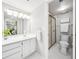 Clean bathroom features a white vanity, toilet and a glass-enclosed shower with gold trim at 1166 Carmel Cir # 120, Casselberry, FL 32707
