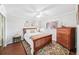 Cozy bedroom with hardwood floors, dresser, closet and bright natural light from the large window at 1166 Carmel Cir # 120, Casselberry, FL 32707