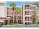 Multi-story condo building featuring balconies, palm trees, and convenient parking at 1166 Carmel Cir # 120, Casselberry, FL 32707