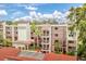 Well-maintained building features multiple floors with balconies and covered parking, situated among lush landscaping at 1166 Carmel Cir # 120, Casselberry, FL 32707