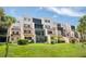 Condo building with screened-in patios and well-maintained green lawn at 1166 Carmel Cir # 120, Casselberry, FL 32707