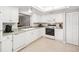 Bright kitchen features white appliances, cabinetry, tile floors and ample storage space at 1166 Carmel Cir # 120, Casselberry, FL 32707