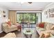 Cozy living room with screened-in patio access and stylish décor at 1166 Carmel Cir # 120, Casselberry, FL 32707
