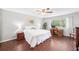 Inviting bedroom features hardwood floors, a ceiling fan, and a desk area near the window at 1166 Carmel Cir # 120, Casselberry, FL 32707