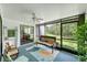 Enclosed sunroom with comfortable seating and views of the lush green backyard at 1166 Carmel Cir # 120, Casselberry, FL 32707