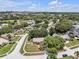 An elevated aerial view of the neighborhood and the surrounding area, with a clear blue sky at 12713 Pine Arbor Dr, Clermont, FL 34711