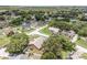 An aerial view of an established neighborhood featuring mature trees, well kept landscaping and nearby streets at 12713 Pine Arbor Dr, Clermont, FL 34711