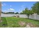 Fenced backyard with grassy area and raised garden beds, perfect for gardening and outdoor enjoyment at 12713 Pine Arbor Dr, Clermont, FL 34711