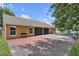 Spacious backyard with a brick patio, a screened-in lanai, perfect for outdoor relaxation and entertaining at 12713 Pine Arbor Dr, Clermont, FL 34711