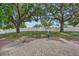 Large brick patio in backyard with mature trees and a white vinyl fence, providing privacy and shade at 12713 Pine Arbor Dr, Clermont, FL 34711