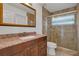 Bathroom featuring granite counter tops, a decorative mirror, tile floors and a glass enclosed shower at 12713 Pine Arbor Dr, Clermont, FL 34711