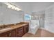 A bathroom featuring double sinks, a shower, and a tub at 12713 Pine Arbor Dr, Clermont, FL 34711