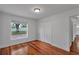 Bedroom featuring hardwood floors, a closet and a bright window at 12713 Pine Arbor Dr, Clermont, FL 34711