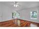 Spacious bedroom featuring hardwood floors, ceiling fan, and French doors leading to outdoor patio at 12713 Pine Arbor Dr, Clermont, FL 34711